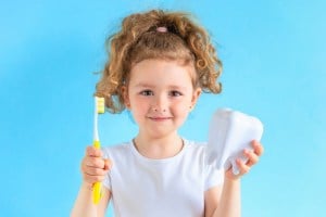 Young Kid holding Toothbrush